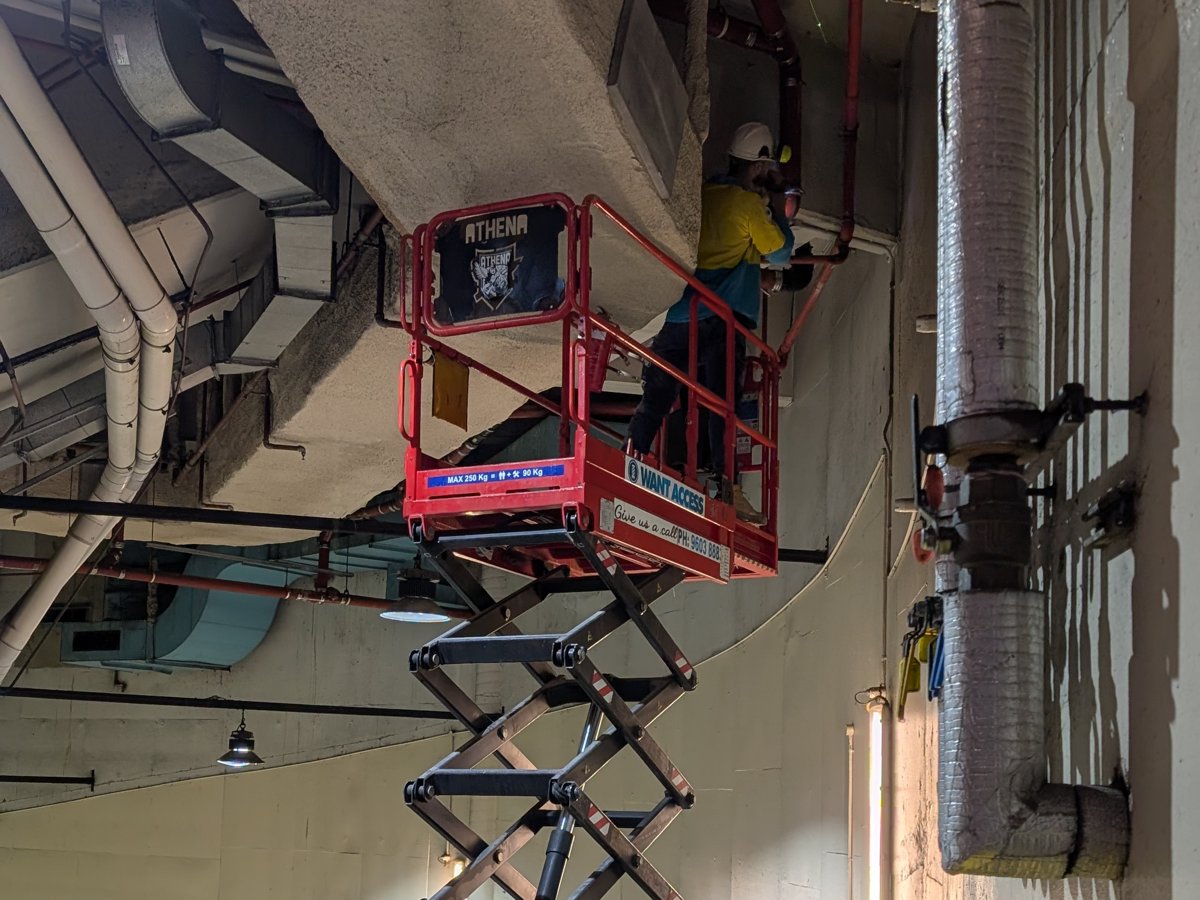 Scissor lift overhead pipework, The Malaya